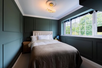 Bedroom with dark green panelling